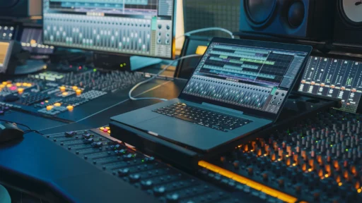 Modern Record Studio Desk with a Laptop Running a Digital Audio Workstation Software